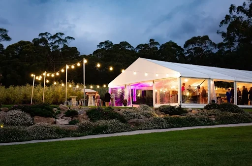 An image of an outdoor event in a marquee.